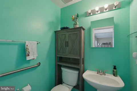 a bathroom with a sink mirror and toilet