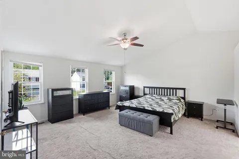 a bedroom with a bed furniture and a window