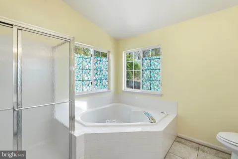 a bathroom with a tub and shower