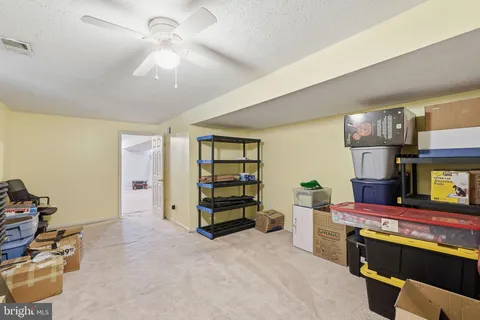 a bathroom with a bathtub shower sink vanity mirror and toilet