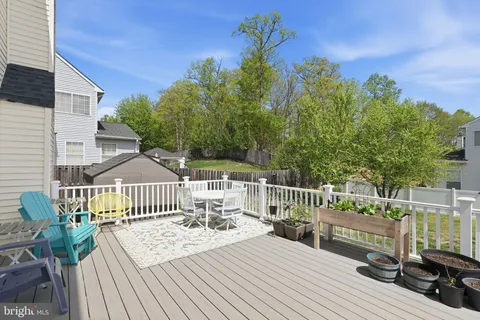 a view of a deck with furniture and wooden fence