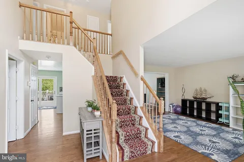 a view of entryway and hall with wooden floor