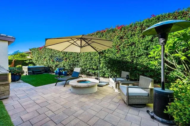 a backyard of a house with yard barbeque oven and outdoor seating