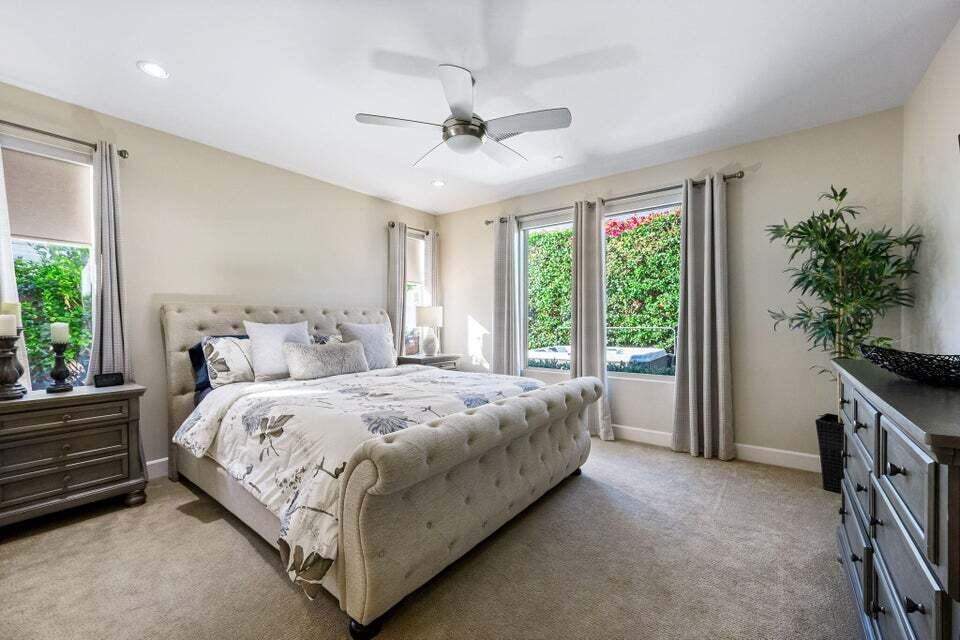 51287 Longmeadow Street Indio, CA 92201 - Photo 11 of 22 a bed sitting in a spacious bedroom next to a window