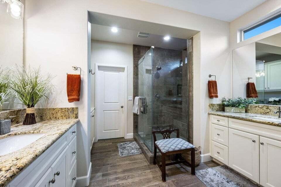51287 Longmeadow Street Indio, CA 92201 - Photo 13 of 22 a spacious bathroom with a granite countertop sink a mirror and shower