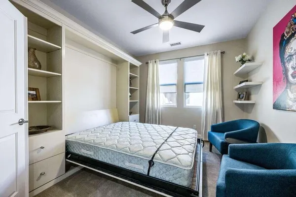 a bedroom with a bed and window