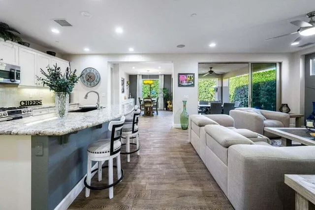 a kitchen with a dining table chairs refrigerator and cabinets