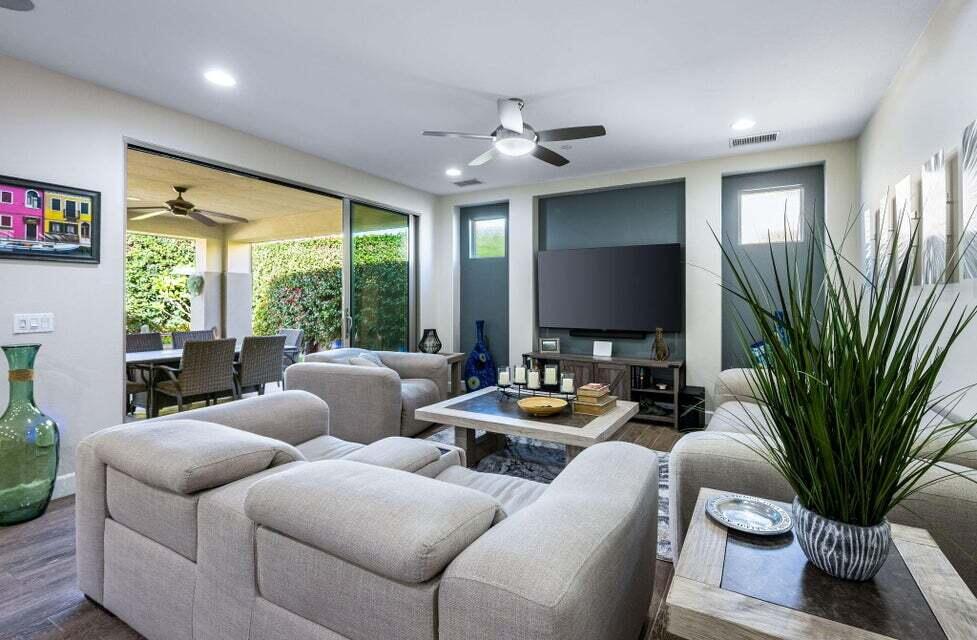 51287 Longmeadow Street Indio, CA 92201 - Photo 7 of 22 a living room with furniture potted plant and a large window