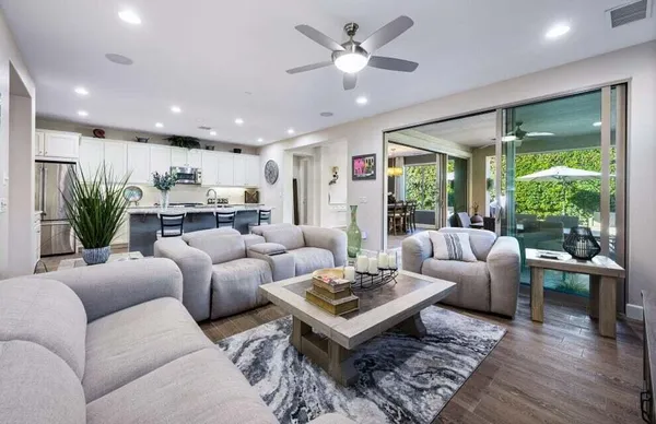 a living room with furniture potted plant and a large window
