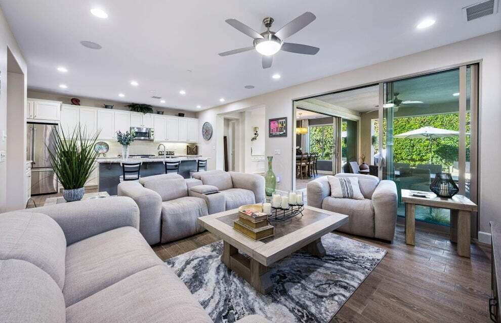 51287 Longmeadow Street Indio, CA 92201 - Photo 8 of 22 a living room with furniture potted plant and a large window