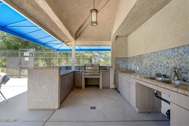 a view of a swimming pool with couches and wooden floor
