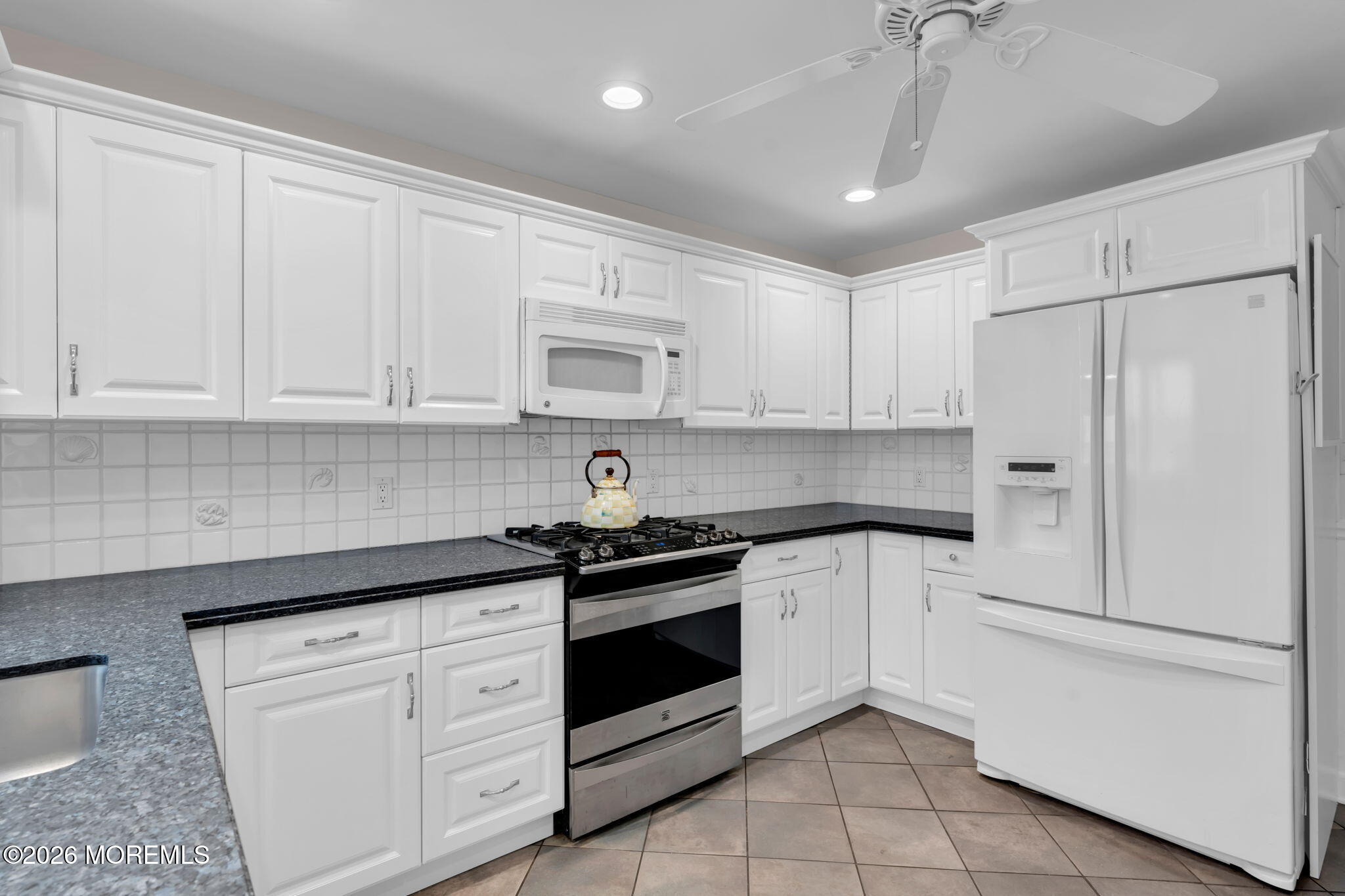 29 Green Island Road Toms River, NJ 08753 - Photo 18 of 63 a kitchen with white cabinets and white appliances