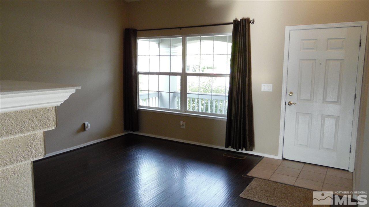 9801 Northrup Drive Reno, NV 89521 - Photo 4 of 18 an empty room with wooden floor and windows