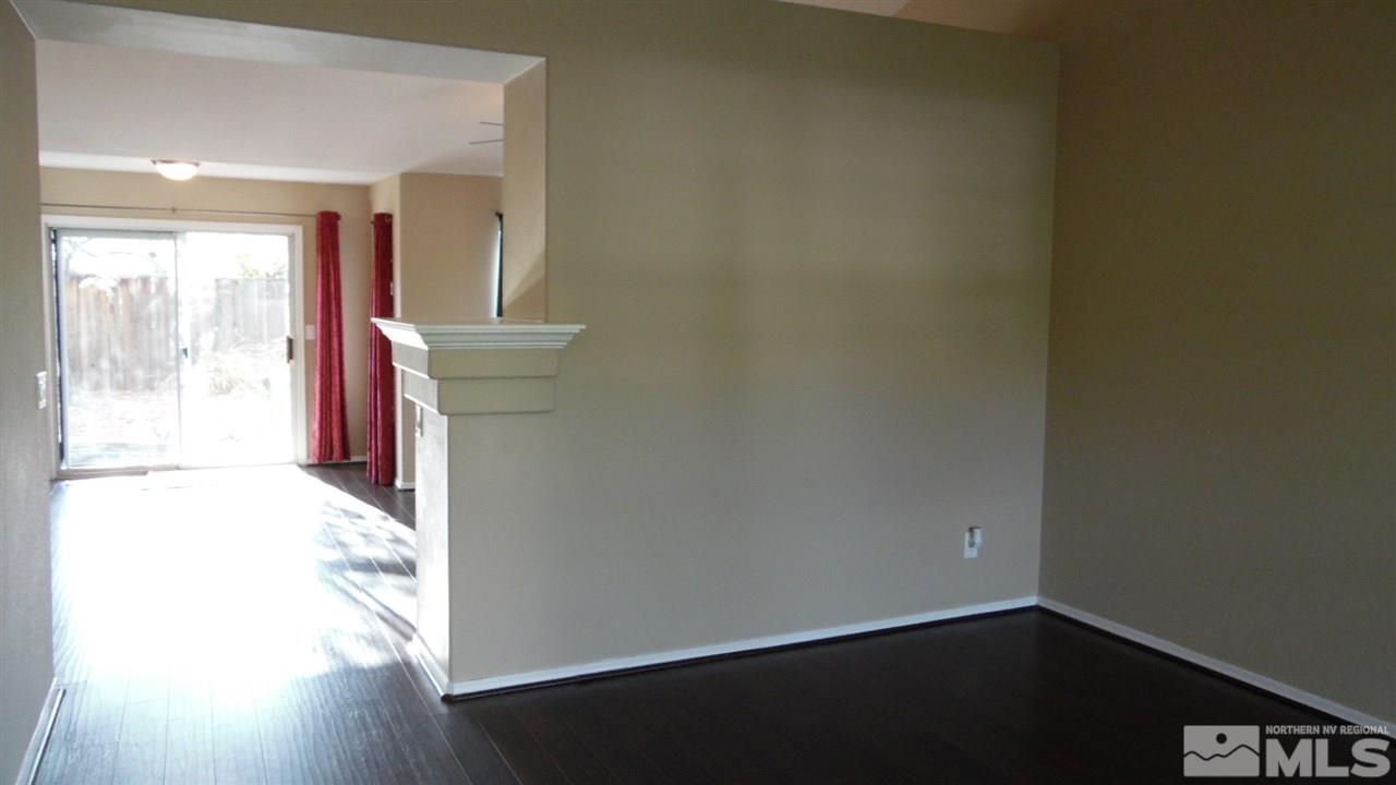 9801 Northrup Drive Reno, NV 89521 - Photo 8 of 18 an empty room with wooden floor and windows