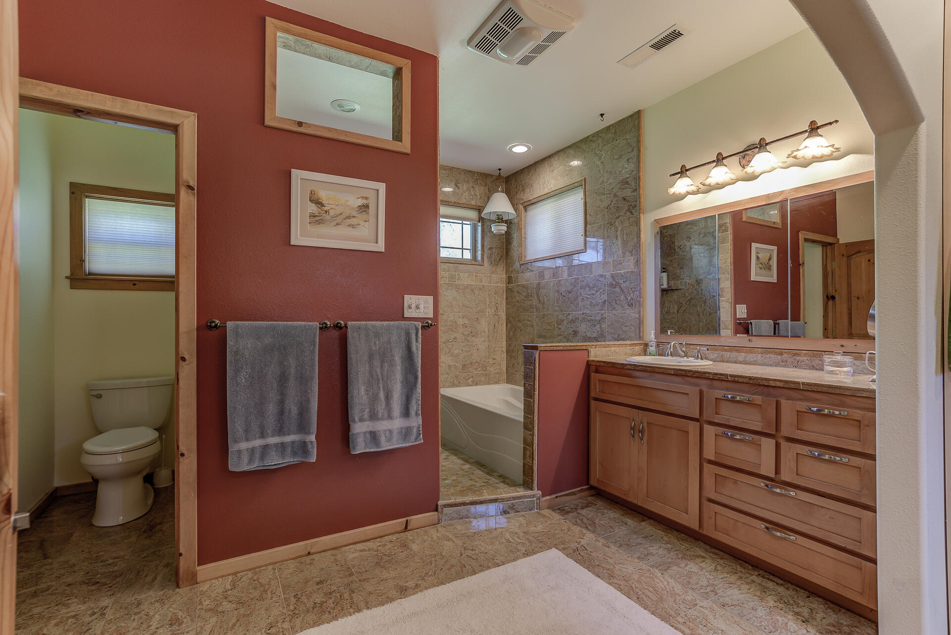2490 Goose Ranch Road Lewiston, CA 96052 - Photo 23 of 38 a spacious bathroom with a granite countertop toilet a sink and a large mirror