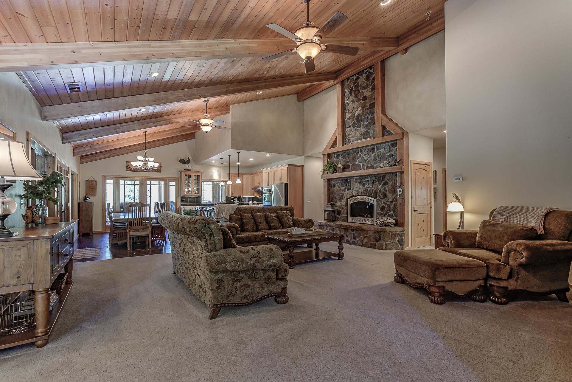 2490 Goose Ranch Road Lewiston, CA 96052 - Photo 4 of 38 a living room with furniture a fireplace and a chandelier