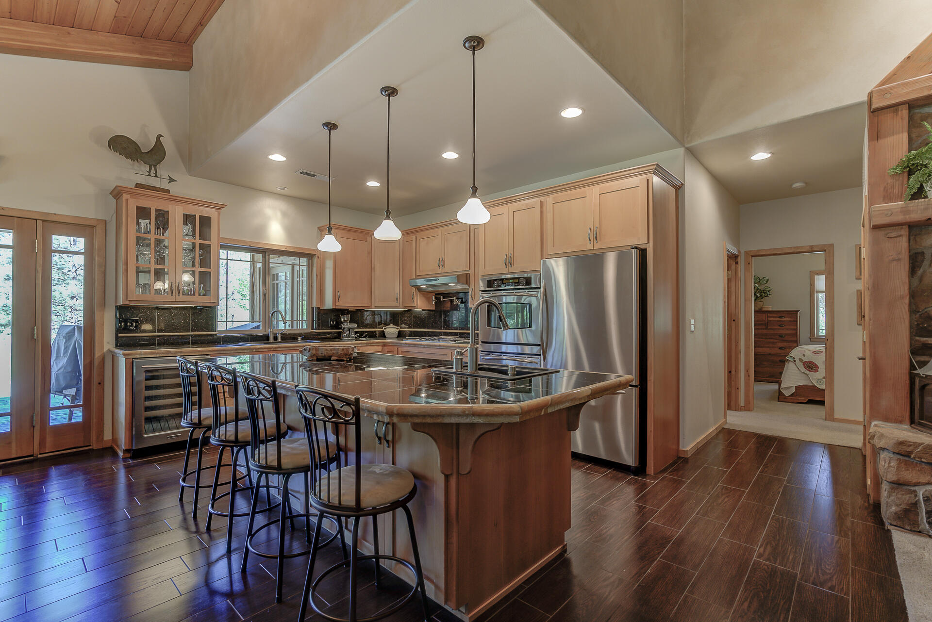 2490 Goose Ranch Road Lewiston, CA 96052 - Photo 8 of 38 a kitchen with stainless steel appliances granite countertop a refrigerator a stove a sink dishwasher a dining table and chairs with wooden floor