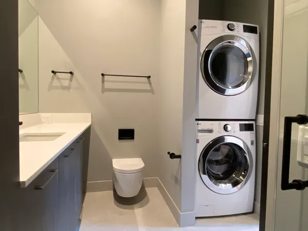 a utility room with sink dryer and washer