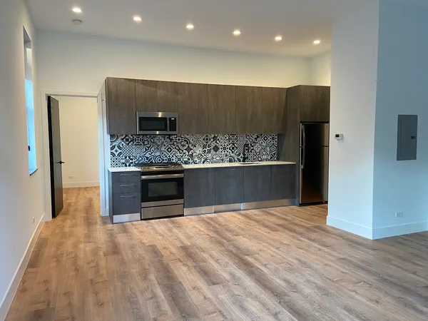 a view of a kitchen with a sink and a fireplace