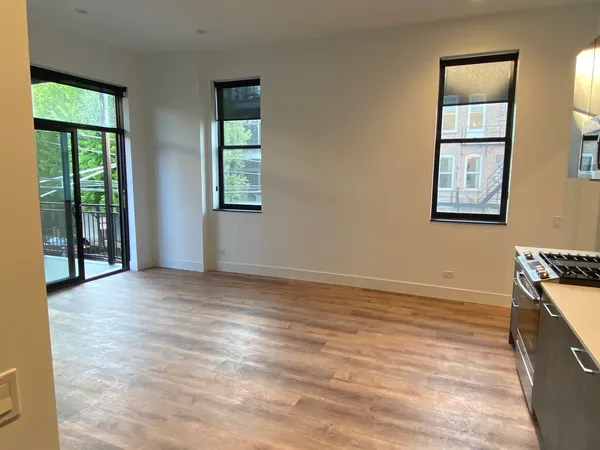 an empty room with windows and closet