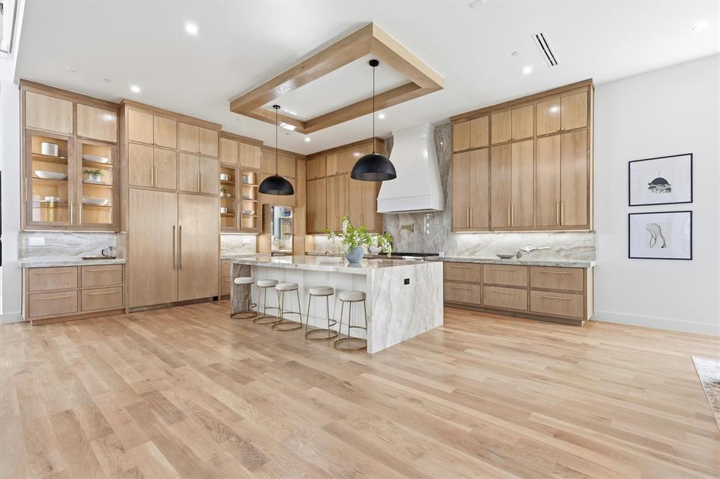 6257 Turner Way Dallas, TX 75230 - Photo 8 of 39 a large white kitchen with cabinets and wooden floor