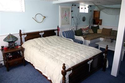 31 Hallet Lane Chatham, MA 02633 - Photo 22 of 22 a bed room with a bed mirror and a chandelier