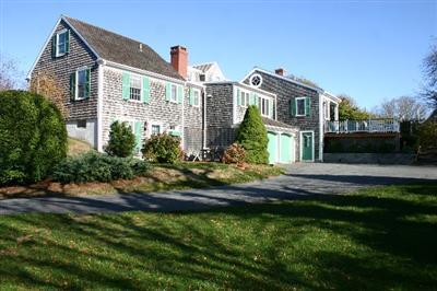 31 Hallet Lane Chatham, MA 02633 - Photo 6 of 22 a front view of a house with a garden and plants