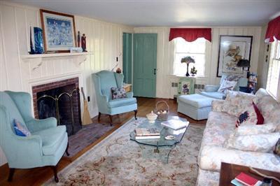 31 Hallet Lane Chatham, MA 02633 - Photo 8 of 22 a living room with furniture a fireplace and wall paintings