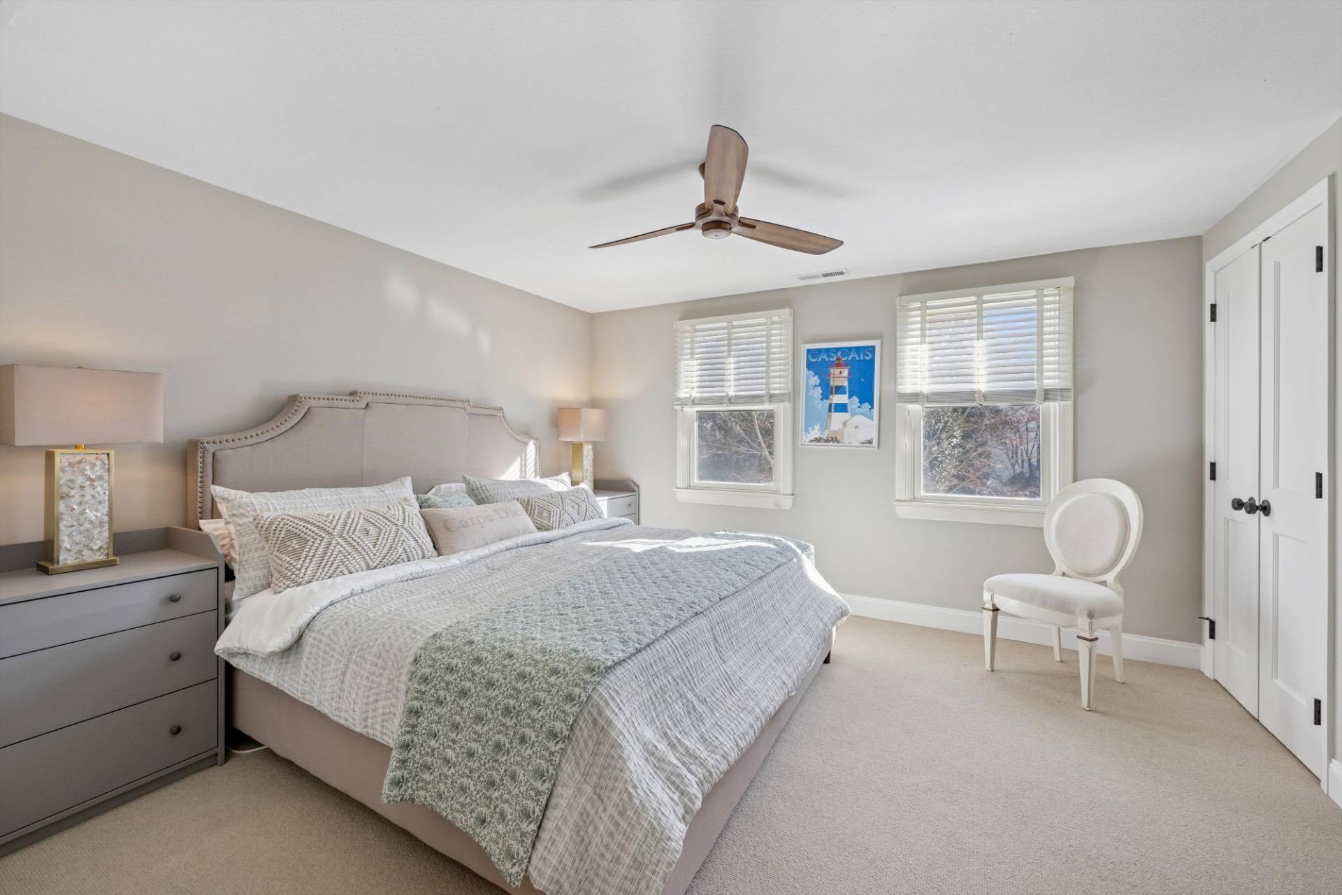 570 Hampton Road, Unit 22 Southampton, NY 11968 - Photo 14 of 26 a bedroom with a bed chairs and a window