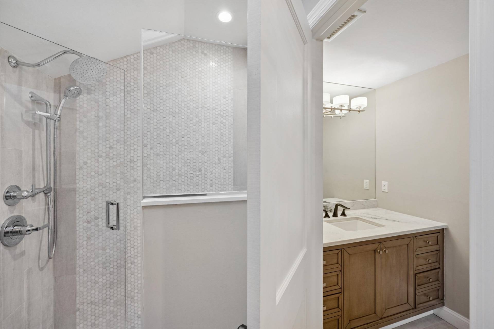 570 Hampton Road, Unit 22 Southampton, NY 11968 - Photo 17 of 26 a bathroom with a sink a mirror and shower