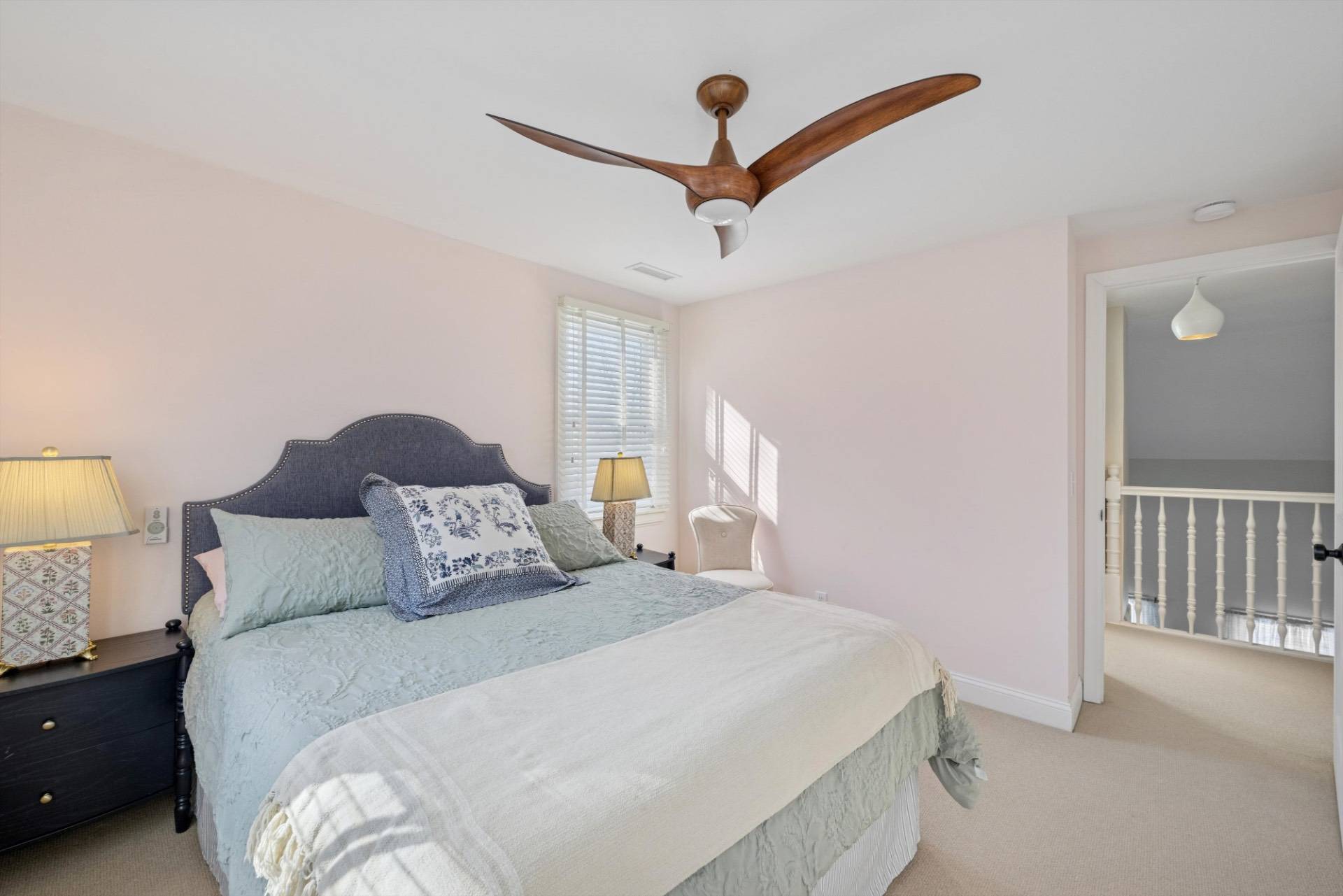 570 Hampton Road, Unit 22 Southampton, NY 11968 - Photo 19 of 26 a bedroom with a bed and a lamp