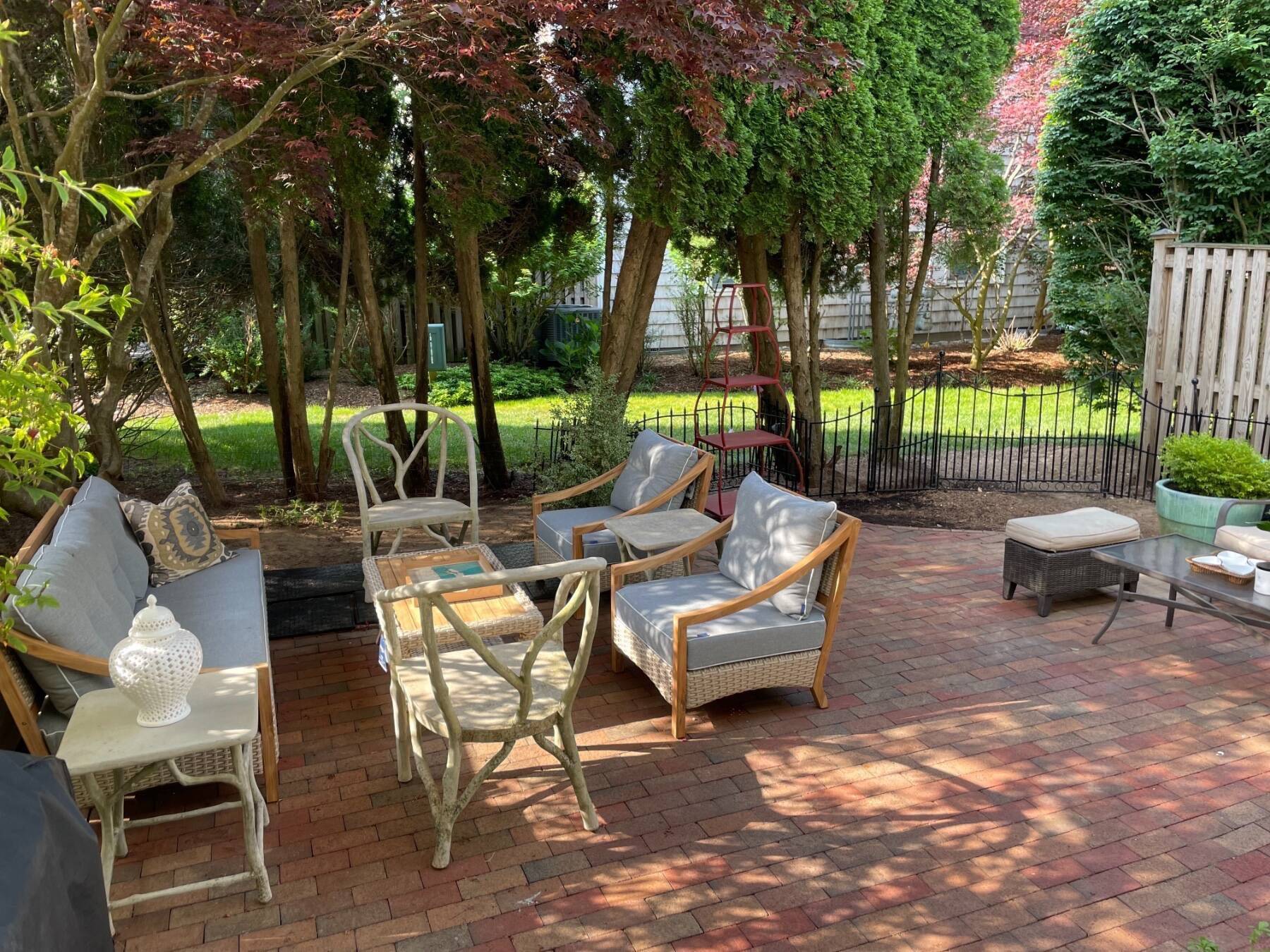 570 Hampton Road, Unit 22 Southampton, NY 11968 - Photo 22 of 26 a view of a patio with a couple of chairs and a fire pit