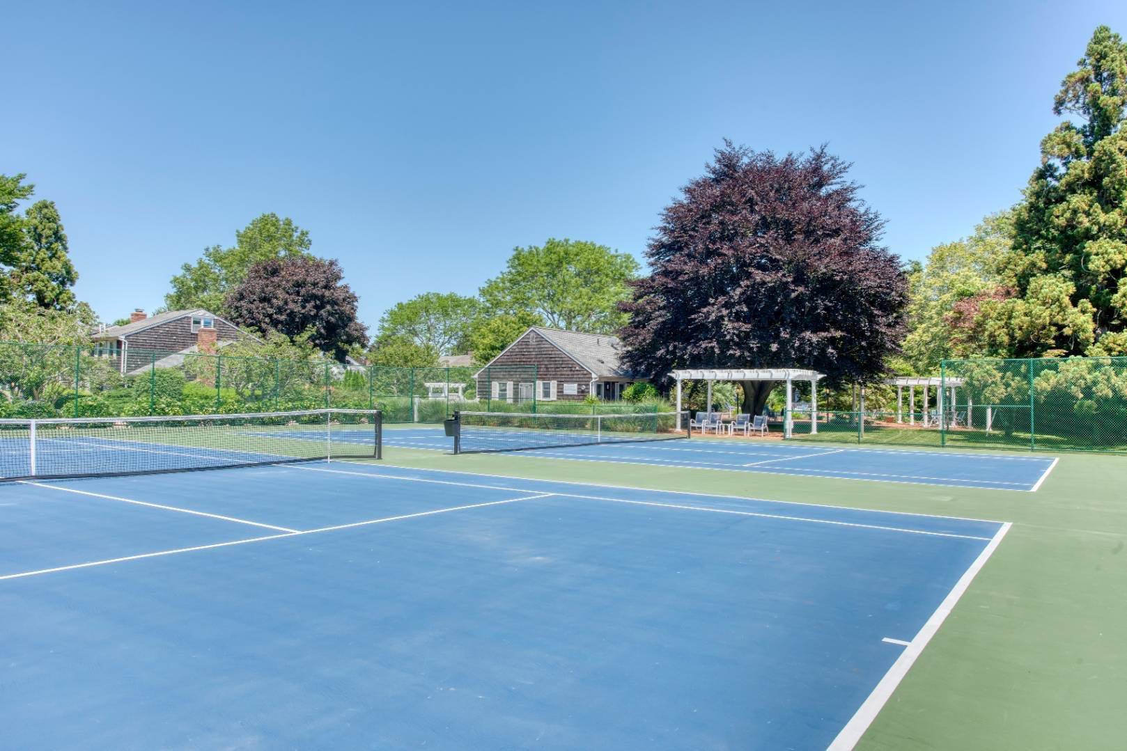 570 Hampton Road, Unit 22 Southampton, NY 11968 - Photo 25 of 26 a view of an outdoor space and tennis court
