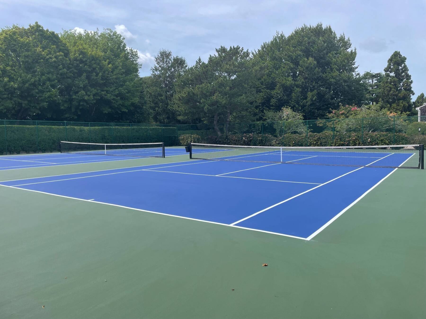 570 Hampton Road, Unit 22 Southampton, NY 11968 - Photo 3 of 26 a tennis court that has tennis net