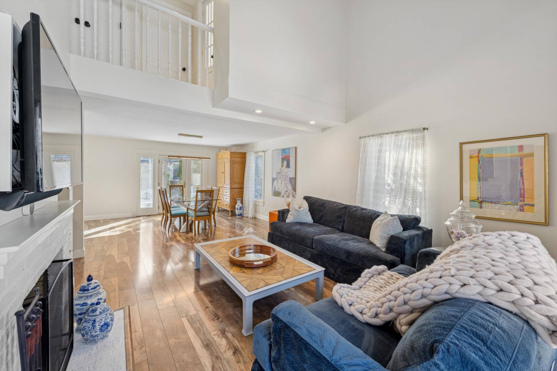 570 Hampton Road, Unit 22 Southampton, NY 11968 - Photo 5 of 26 a living room with furniture and a flat screen tv
