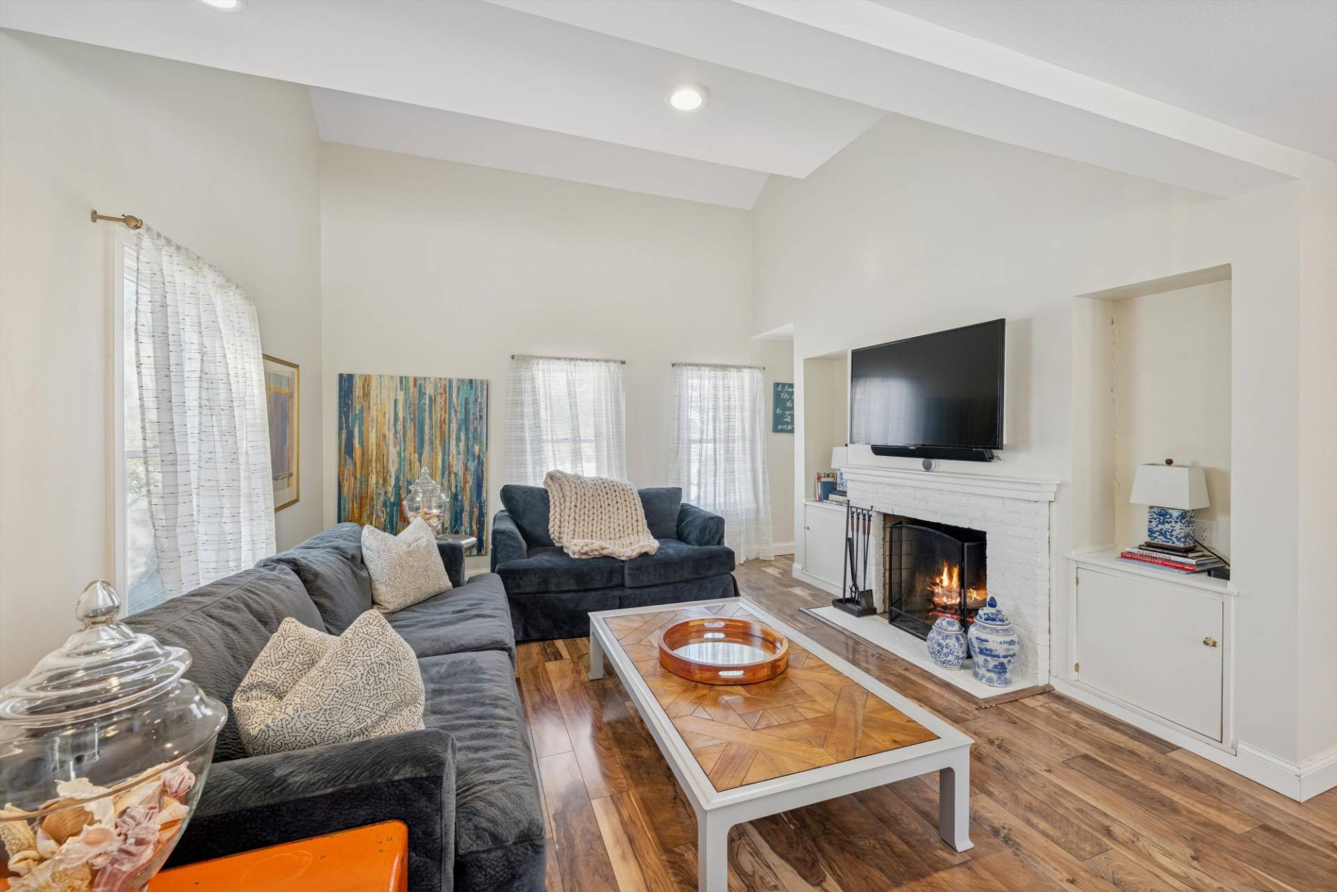 570 Hampton Road, Unit 22 Southampton, NY 11968 - Photo 6 of 26 a living room with furniture a flat screen tv and a fireplace