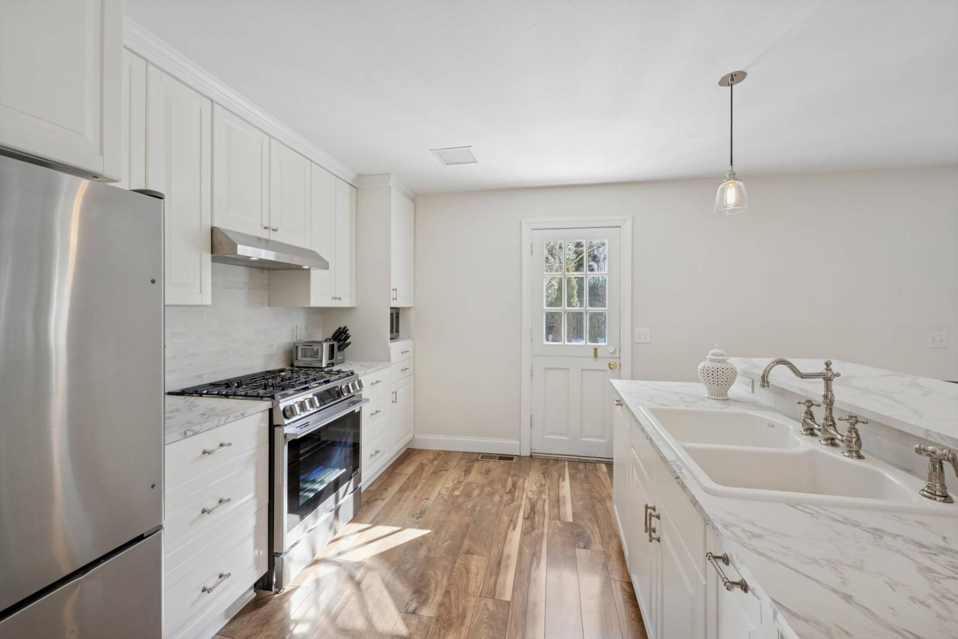 570 Hampton Road, Unit 22 Southampton, NY 11968 - Photo 9 of 26 a kitchen with a sink stove and refrigerator