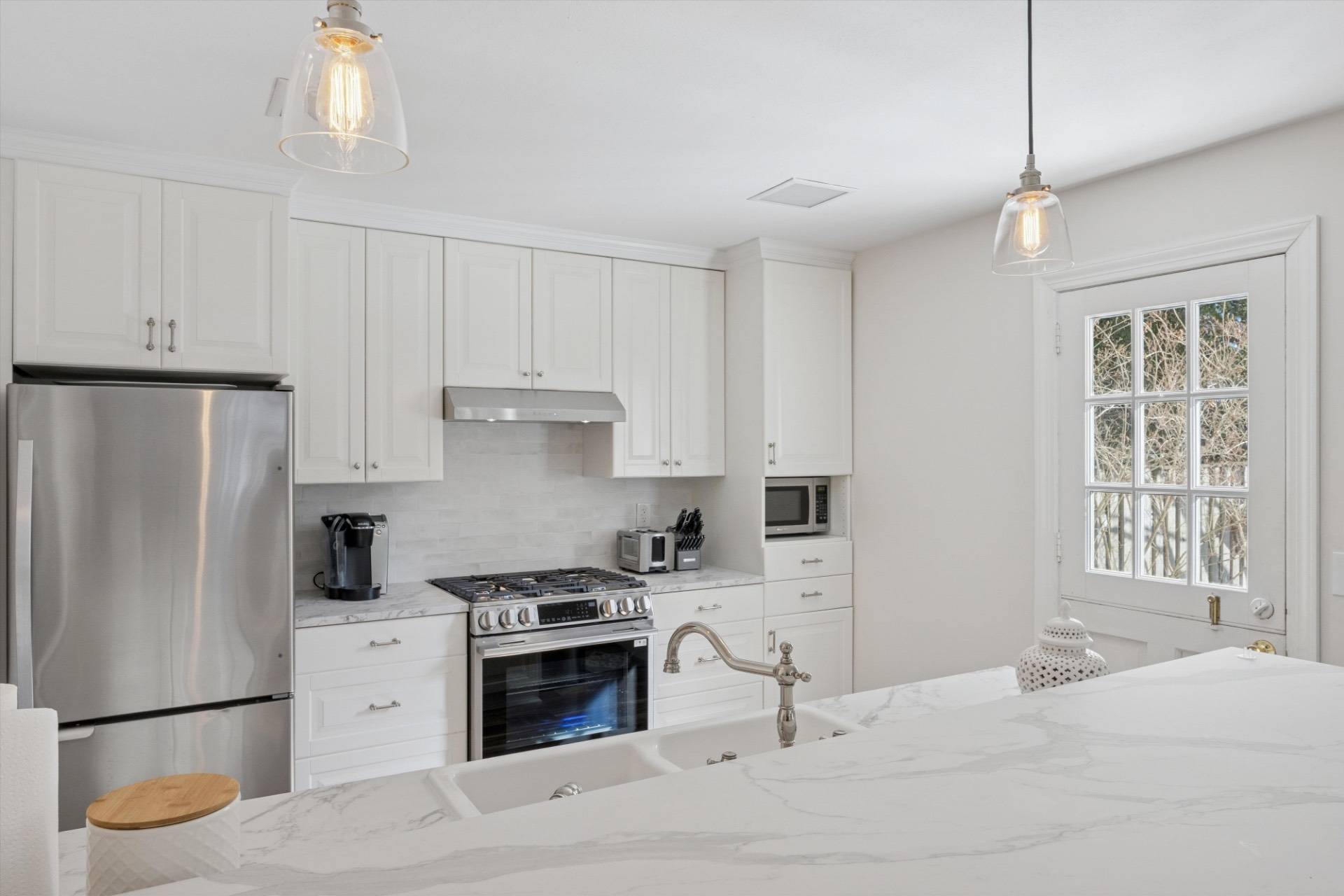 570 Hampton Road, Unit 22 Southampton, NY 11968 - Photo 10 of 26 a kitchen with a refrigerator stove and white cabinets