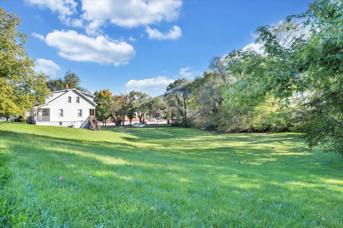 2-3 Plantation Road Northeast Roanoke, VA 24012 - Photo 4 of 13 a view of white house with a big yard and garden