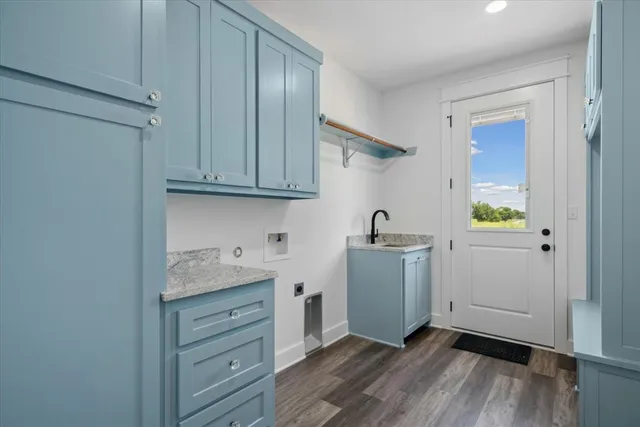 a bathroom with a granite countertop sink a toilet and vanity