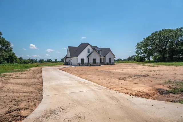 a view of a house with a snow on the road