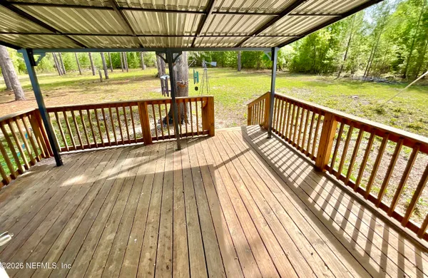 a view of balcony with wooden floor