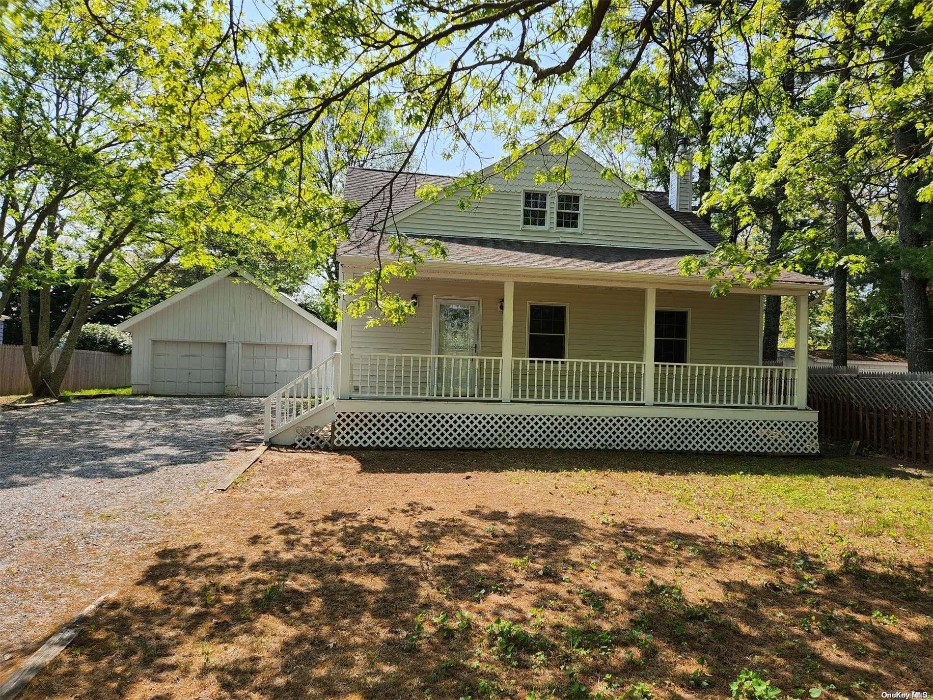 a front view of a house with a garden and yard