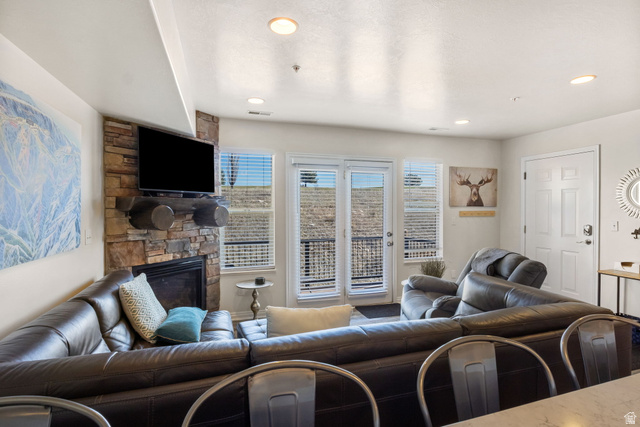 3598 North Huntsman Path, Unit 502 Eden, UT 84310 - Photo 8 of 43 Living room featuring a stone fireplace