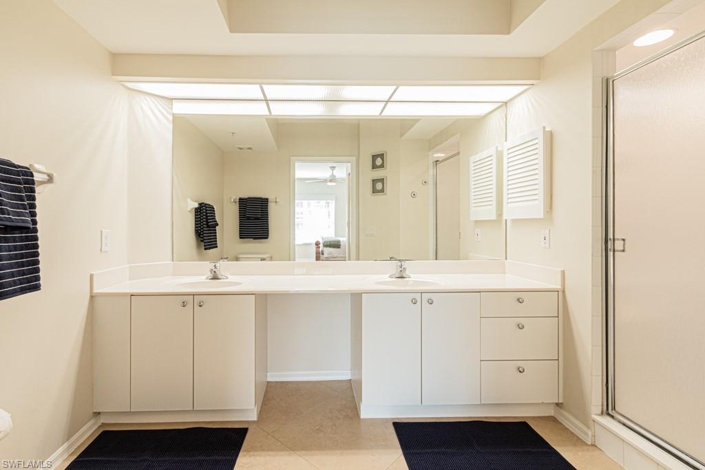 6914 Satinleaf Road North, Unit 104 Naples, FL 34109 - Photo 16 of 44 Primary Bathroom with Dual sinks and step-in shower