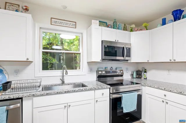 a view of a dining room with furniture wooden floor and a painting