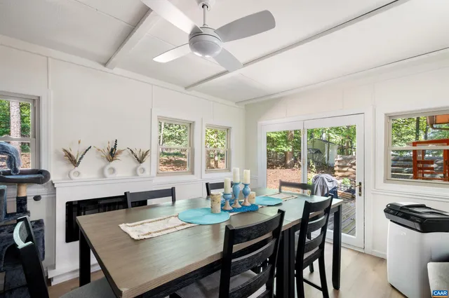 a living room with a flat screen tv a rug and a window