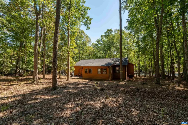 a view of backyard with swimming pool and outdoor seating