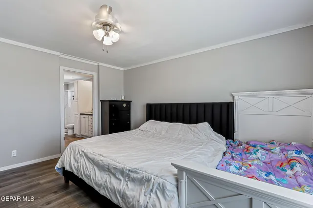 a bathroom with a granite countertop sink a toilet a mirror and shower