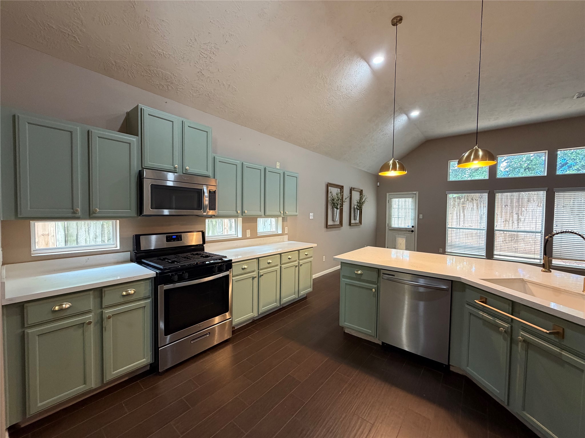 903 Cascade Ridge Katy, TX 77494 - Photo 8 of 24 a kitchen with stainless steel appliances granite countertop wooden cabinets a sink a stove and a refrigerator